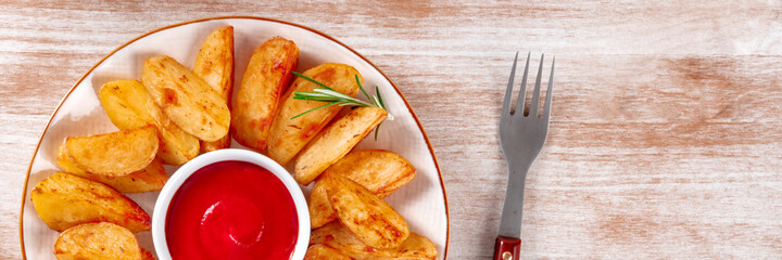 Baked potato wedges panorama with a place for text or logo on a rustic background