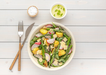 Grilled green asparagus salad with fresh radish, arugula, potatoes, and parmesan cheese.