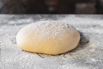 Fototapeta na wymiar Dough makes fresh bread on the kitchen table.