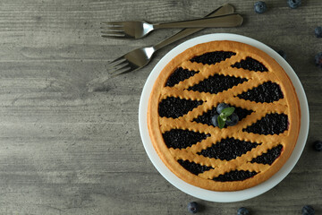 Delicious blueberry pie on gray textured background