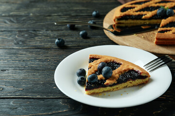 Delicious blueberry pie on rustic wooden background