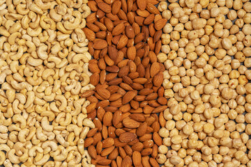 Close-up of nuts background: cashews, hazelnuts, almonds. Healthly food. A source of vitamins, microelements.