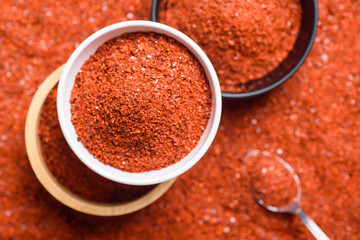 Red cayenne pepper, Chili flakes, Chili powder in a bowl with spoon, Top view
