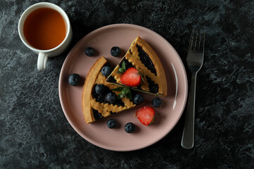 Concept of delicious food with blueberry pie on black smokey background