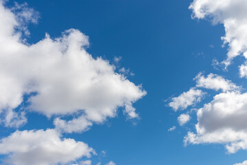 Naklejka na ściany i meble Blue sky background with white clouds.Cloudscape. Sunny day. Cumulus cloud.