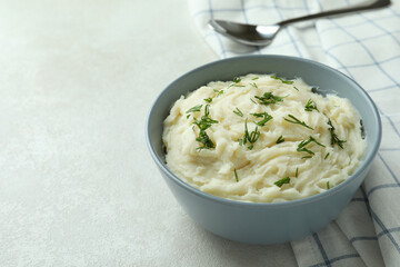 Bowl of mashed potatoes on white textured background
