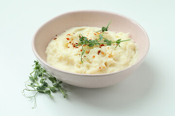 Plate of mashed potatoes on white background