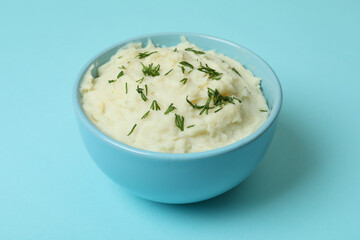 Plate of mashed potatoes on blue background
