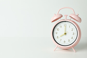 Stylish mint alarm clock on soft background