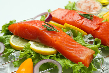 Concept of cooking salmon on white background