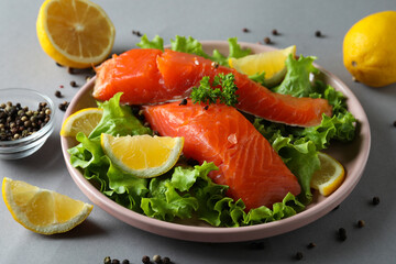 Concept of cooking salmon on gray background