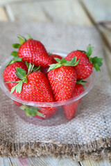 Fresh ripe strawberries in a plastic bowl. Large strawberries.