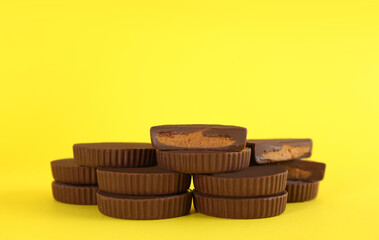 Sweet peanut butter cups on yellow background