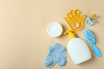 Different baby hygiene accessories on beige background