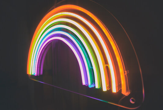 The led neon rainbow shines in the dark room