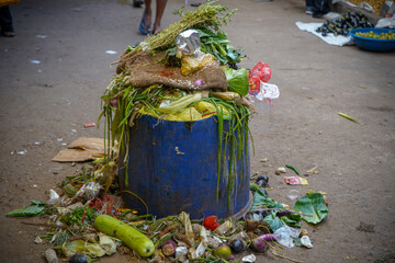 Closeup shot of an overflowing trash can at a market