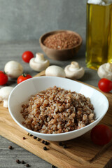 Concept of tasty eating with buckwheat on gray textured table