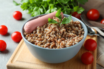 Concept of tasty eating with buckwheat on gray table