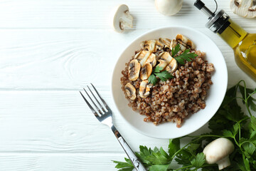 Concept of tasty eating with buckwheat on wooden table