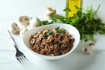 Concept of tasty eating with buckwheat on wooden table