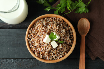 Concept of tasty eating with buckwheat on wooden table