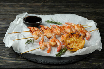 Tasty grilled shrimps on rustic wooden background