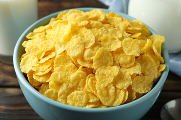 Concept of tasty breakfast with cornflakes on wooden table, close up