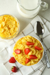Concept of tasty breakfast with cornflakes on white textured table