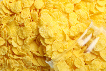 Jar with corn flakes on corn flakes background