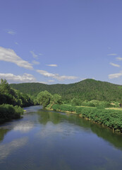 Fototapeta na wymiar Stylish travel wallpaper. Slovenia. Green and river. Nature aesthetics