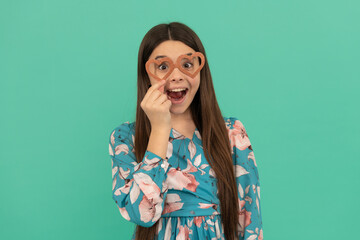 Make it fun. Funny child wear heart-shaped glasses. Surprised girl. Valentines day fun