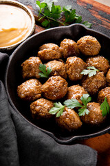  Traditional swedish meatballs with creamy sauce on old wooden table close up vertical photo