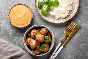  Traditional swedish meatballs with creamy sauce and mashed potatoes on gray background top view