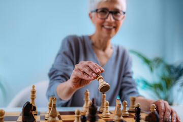 Senior Woman Playing Chess. Cognitive Rehabilitation Therapy.