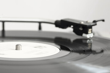 A spinning vinyl record on a turntable. Photo was taken in motion. Selective focus.