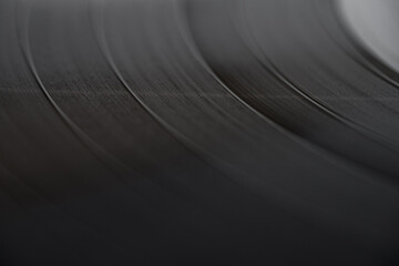 Close-up look of a black vinyl record. Selective focus.