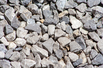 Gray gravel stones for the construction industry. Gravel texture