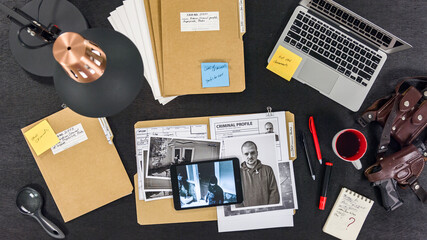 General view of the police detective's desk. The policeman is investigating. - obrazy, fototapety, plakaty