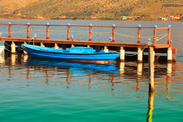 Fototapeta na wymiar Bluel boat with, in Aitoliko sea lake in Central Greece