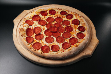 Italian pepperoni pizza on wooden board