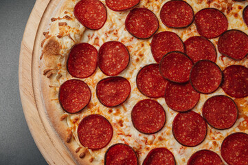 Italian pepperoni pizza on wooden board