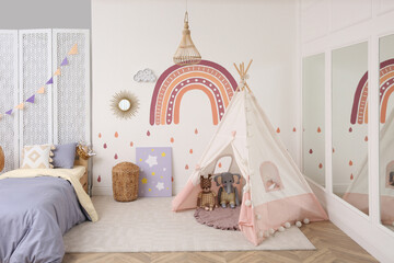 Stylish room with comfortable bed and teepee tent for kids. Interior design © New Africa