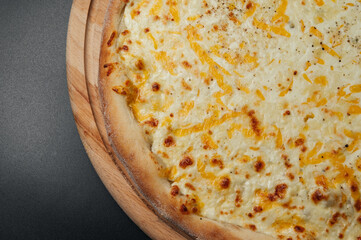Delicious pizza Four Cheeses with cheddar, Parmesan, mozzarella and tomato sauce.