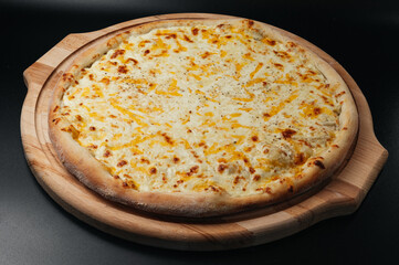 Delicious pizza Four Cheeses with cheddar, Parmesan, mozzarella and tomato sauce.