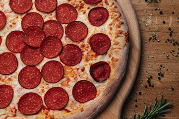 Italian pepperoni pizza on wooden board