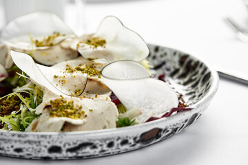 Traditional Italian appetizer vitello tonnato of thinly sliced marinated veal, seasoned with cream sauce and tuna