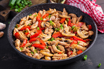 Stir fry with chicken, mushrooms and sweet peppers - Chinese food.