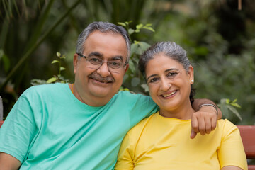 PORTRAIT OF A HAPPY COUPLE SITTING TOGETHER