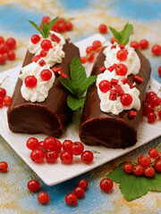 Swiss roll with chocolate and cream.