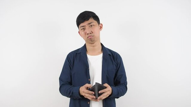 Asian man feeling sad with his wallet in hand poor man concept,Man no money in wallet white background